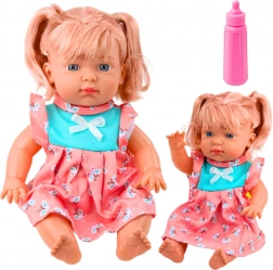 Bambola bebè in abiti colorati con biberon e suoni