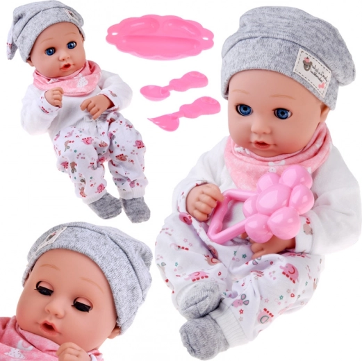 Bambola bebè 32 cm con palpebre mobili e set per la pappa
