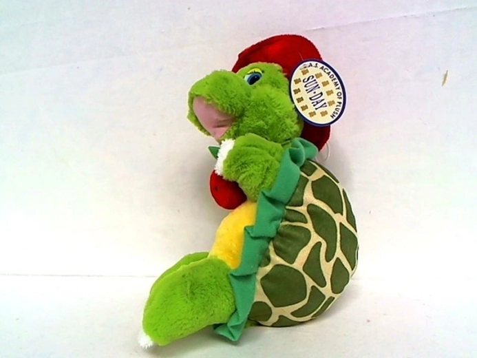 Tartaruga di peluche con cappello rosso e mela