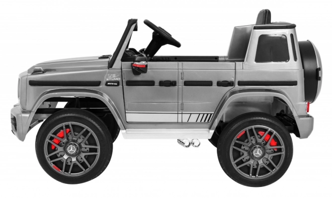 Mercedes AMG G63 per bambini Vernice argento + telecomando + MP3 LED + avvio lento + EVA + cinture