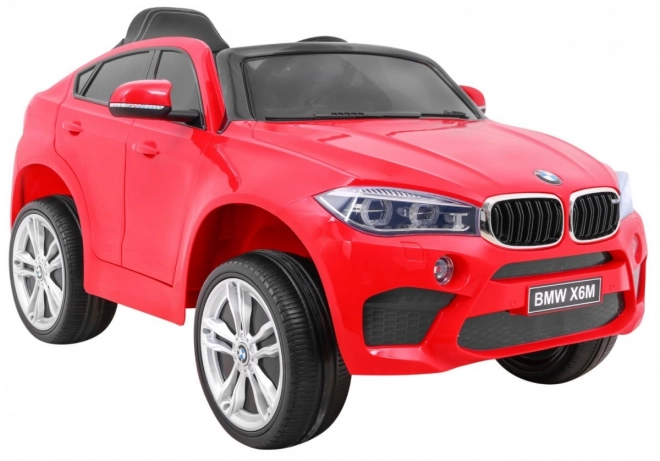 BMW X6M Auto elettrico per bambini rosso + telecomando + EVA + avvio lento + pannello audio + LED