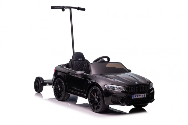 Auto elettrica per bambini BMW M5 con pedana per genitori nero lucido