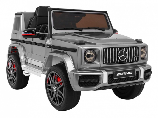 Mercedes AMG G63 per bambini Vernice argento + telecomando + MP3 LED + avvio lento + EVA + cinture
