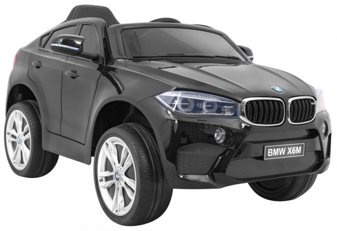Auto elettrico per bambini BMW X6M nero + telecomando + EVA + avvio lento + pannello audio + LED