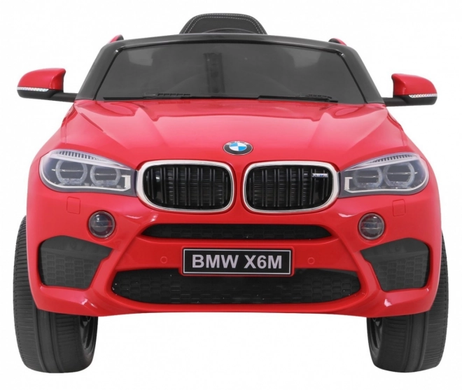 BMW X6M Auto elettrico per bambini rosso + telecomando + EVA + avvio lento + pannello audio + LED