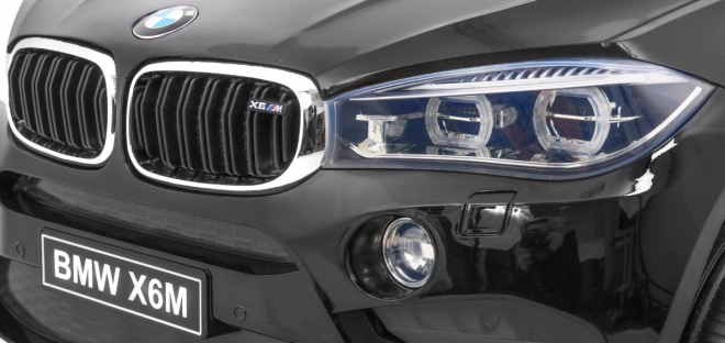 Auto elettrico per bambini BMW X6M nero + telecomando + EVA + avvio lento + pannello audio + LED