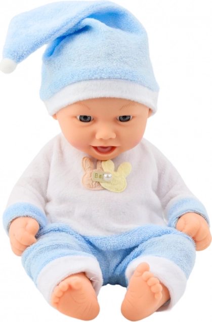 Bambola di bambino in pigiama blu con cappellino con pon pon