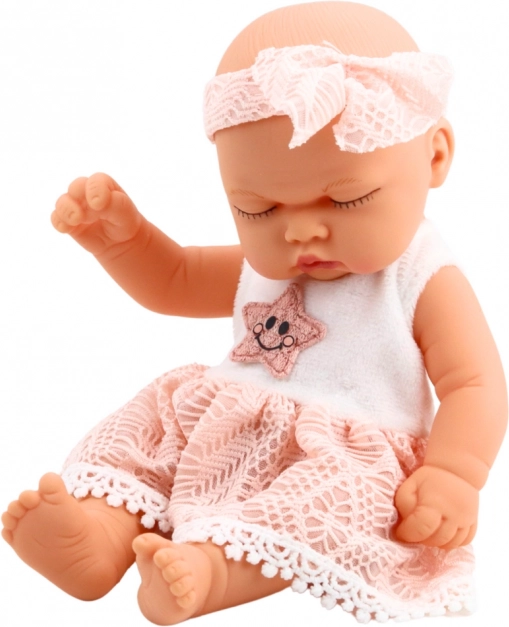 Bambola neonata che dorme in abito rosa con pizzo e fascia con stelline