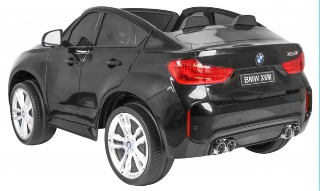 BMW X6M XXL pro 2 bambini Vernice nera + Telecomando + Pelle Eko + Cinture di sicurezza + Partenza lenta + MP3 + LED