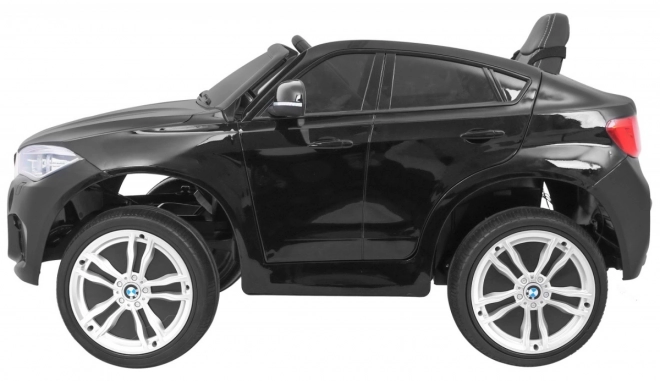 Auto elettrico per bambini BMW X6M nero + telecomando + EVA + avvio lento + pannello audio + LED