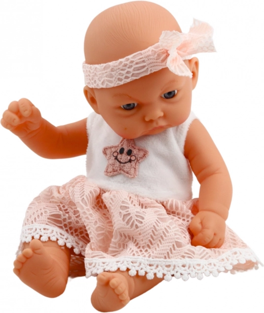 Bambola bebè in vestito rosa con cerchietto