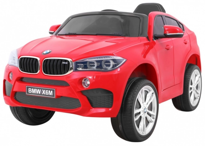 BMW X6M Auto elettrico per bambini rosso + telecomando + EVA + avvio lento + pannello audio + LED