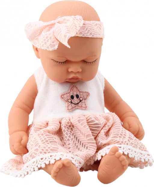 Bambola neonata che dorme in abito rosa con pizzo e fascia con stelline