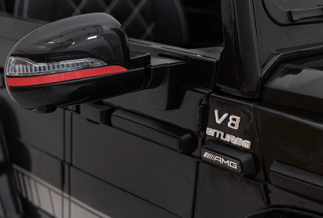 Mercedes AMG G63 per bambini nero + telecomando + MP3 LED + partenza lenta + EVA + cinture di sicurezza