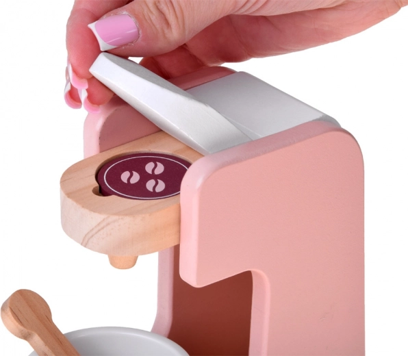 Macchina del caffè a capsule con tazza e cucchiaino