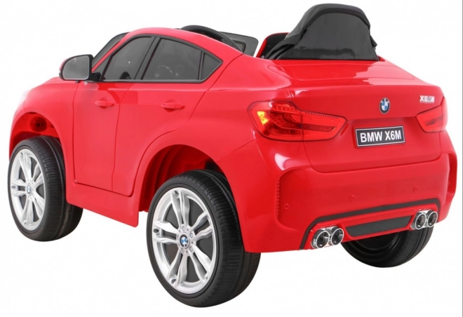 BMW X6M Auto elettrico per bambini rosso + telecomando + EVA + avvio lento + pannello audio + LED