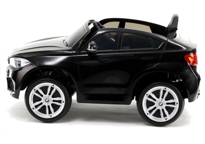 Auto elettrico per bambini BMW X6 nero con sedili in ecopelle