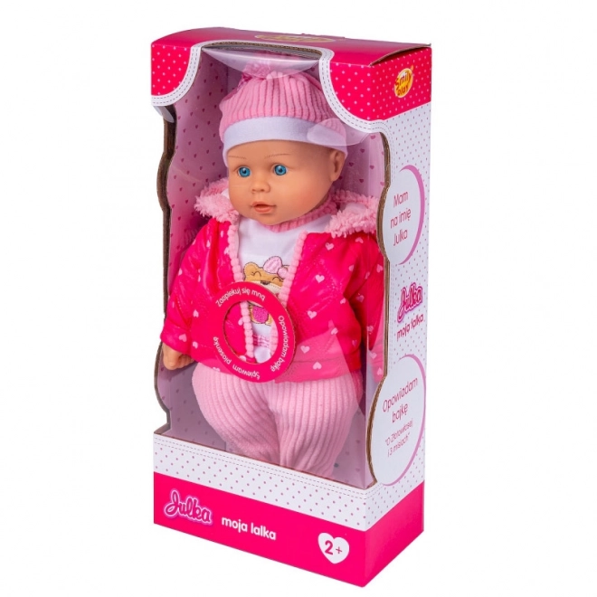 bambola Julka interattiva con cappottino rosa