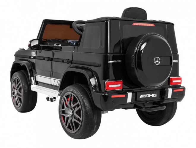 Mercedes AMG G63 per bambini Laccato nero + telecomando + MP3 LED + partenza lenta + EVA + cinture