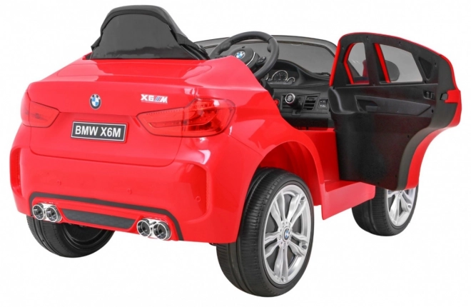BMW X6M Auto elettrico per bambini rosso + telecomando + EVA + avvio lento + pannello audio + LED
