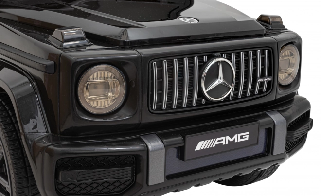 Mercedes AMG G63 per bambini nero + telecomando + MP3 LED + partenza lenta + EVA + cinture di sicurezza