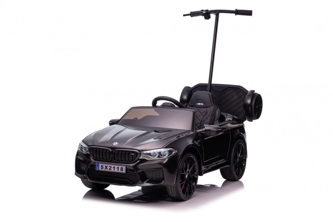 Auto elettrica per bambini BMW M5 con pedana per genitori nero lucido