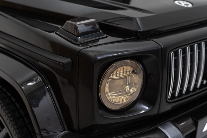 Mercedes AMG G63 per bambini nero + telecomando + MP3 LED + partenza lenta + EVA + cinture di sicurezza