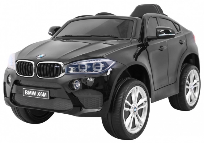 Auto elettrico per bambini BMW X6M nero + telecomando + EVA + avvio lento + pannello audio + LED