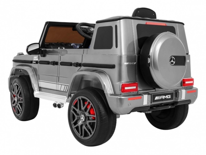 Mercedes AMG G63 per bambini Vernice argento + telecomando + MP3 LED + avvio lento + EVA + cinture