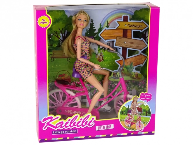 Bambola in bicicletta rosa