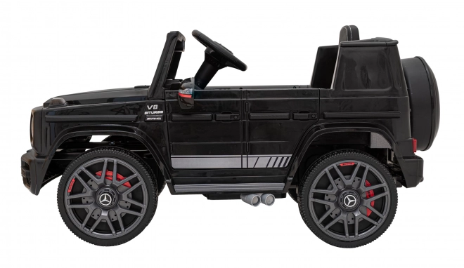 Mercedes AMG G63 per bambini nero + telecomando + MP3 LED + partenza lenta + EVA + cinture di sicurezza